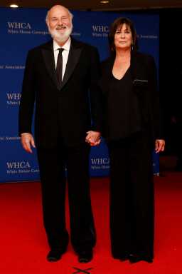 a man and woman wearing black on a red carpet