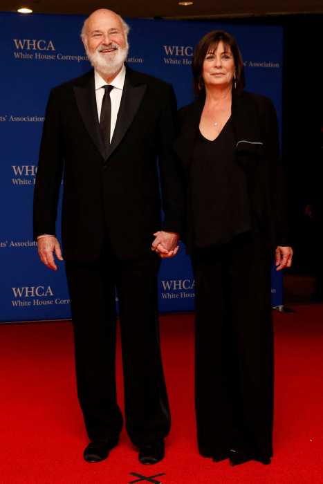 a man and woman wearing black on a red carpet
