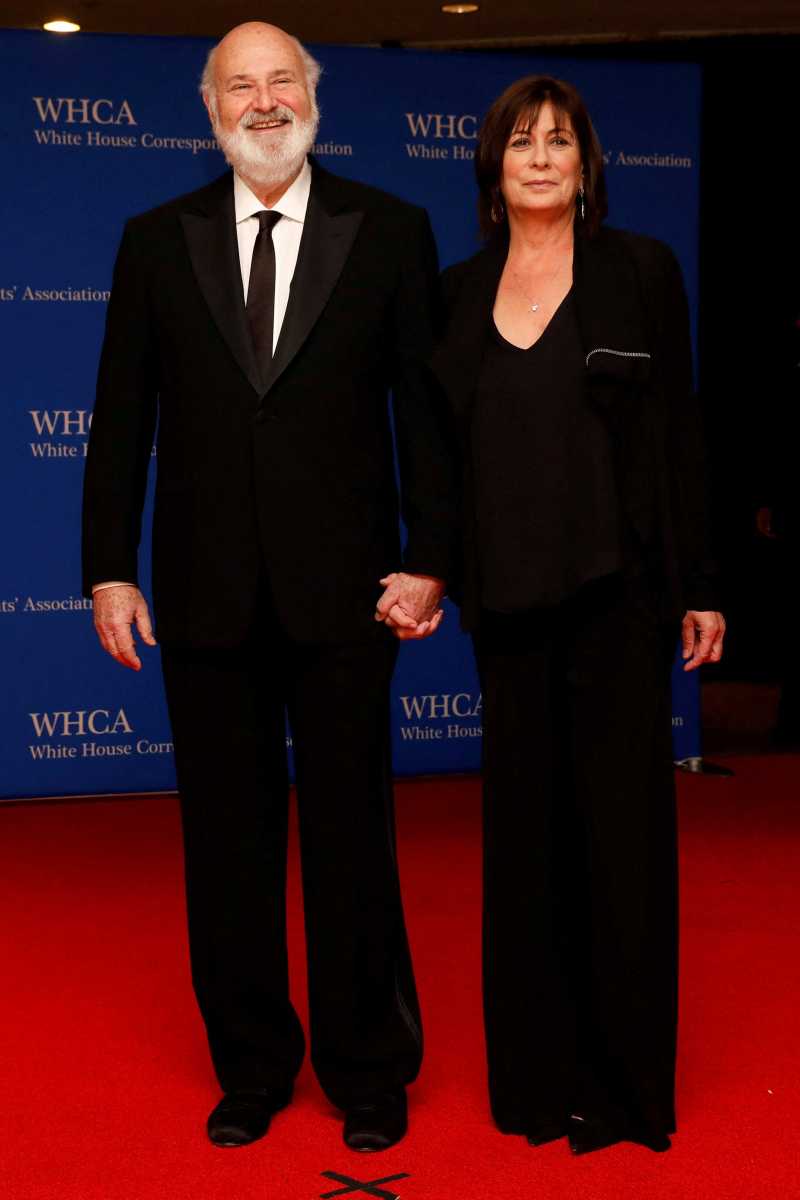 a man and woman wearing black on a red carpet