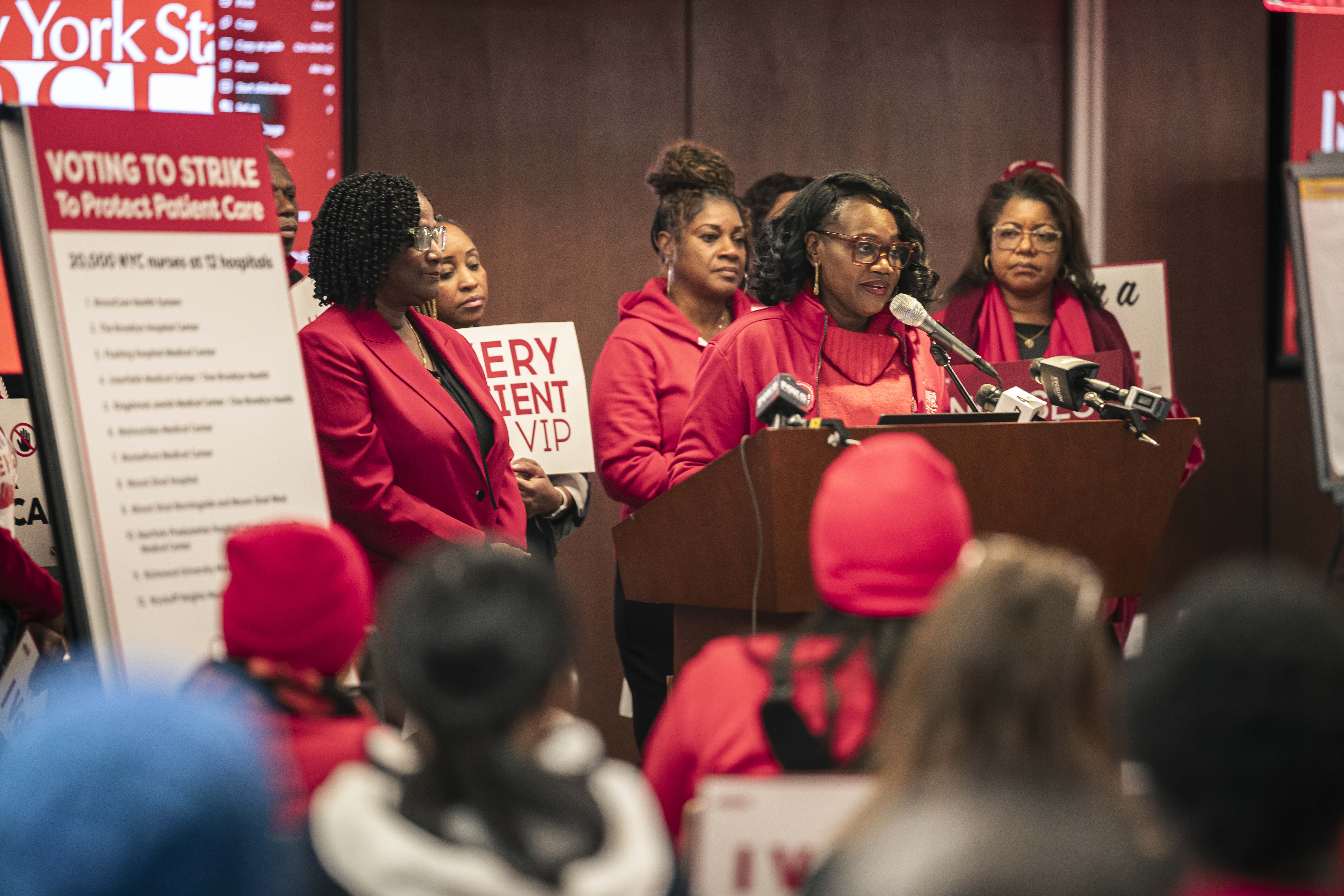 people dressed in red at a podium