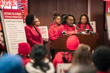 people dressed in red at a podium