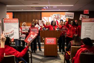 people dressed in red at a podium