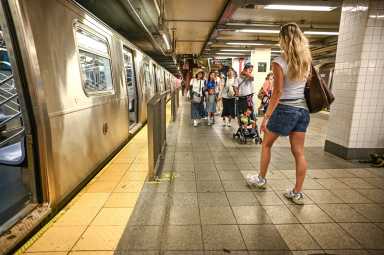 transit riders approach subway in summer of 2025