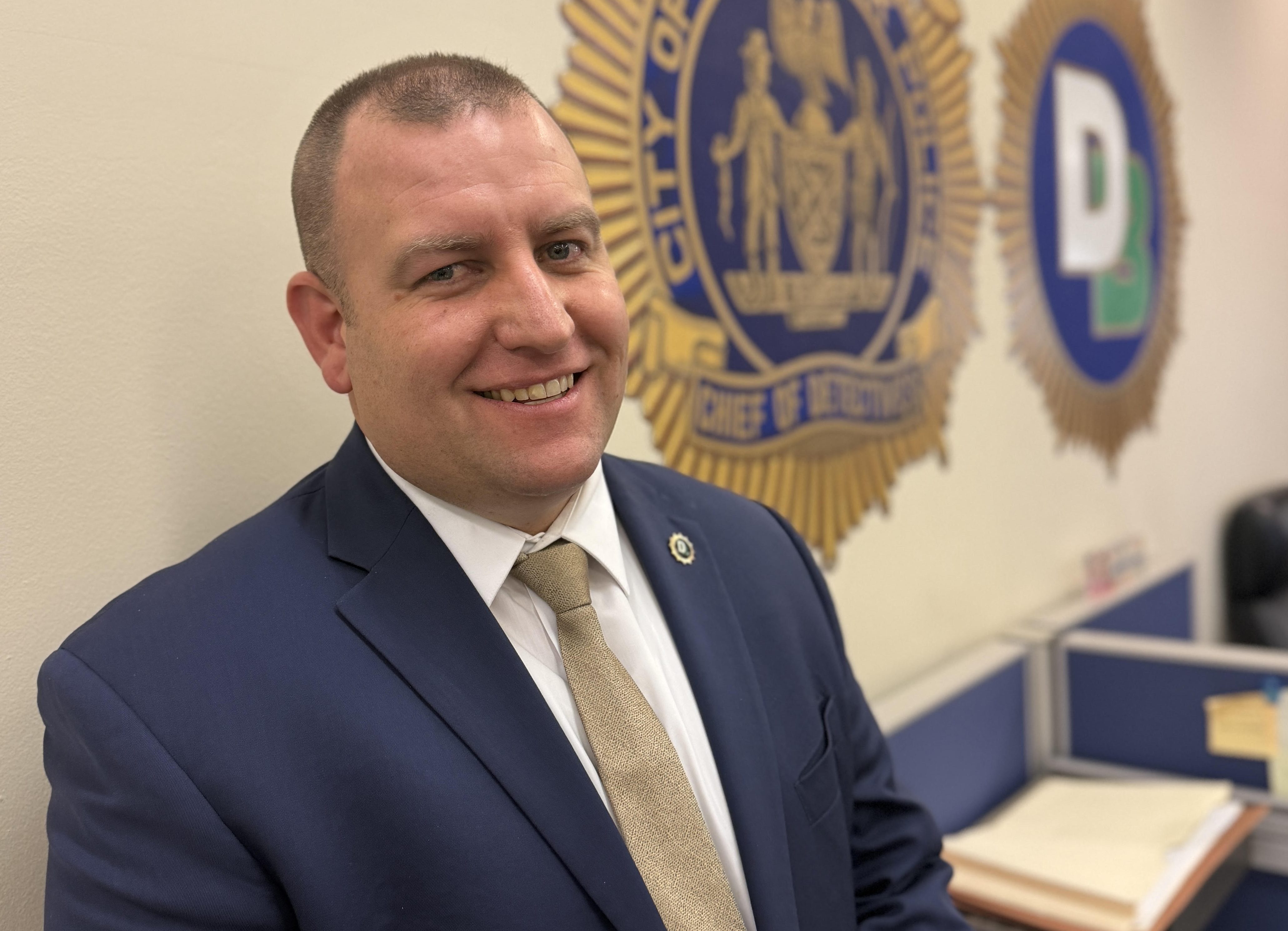 NYPD detective smiling who saved choking baby