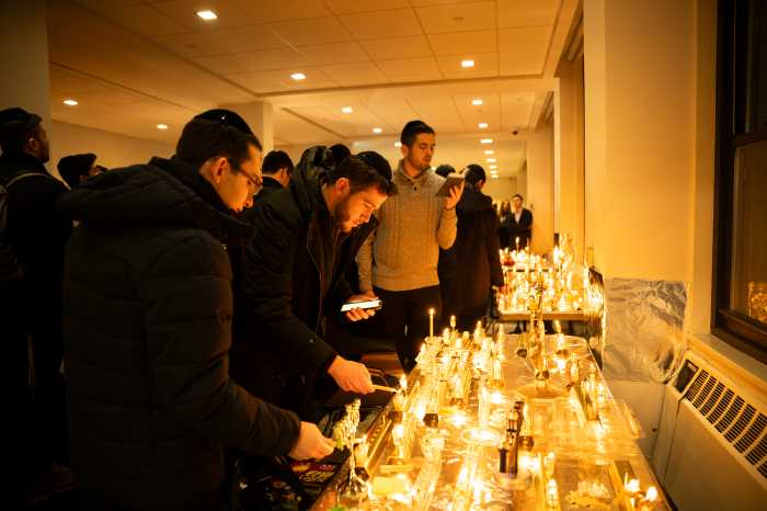 Students at Yeshiva University light candles for victims of Australia terror attack on Hanukkah
