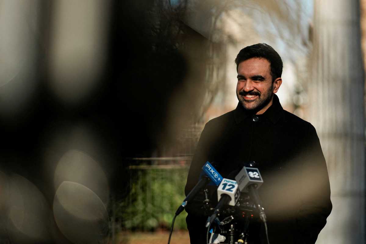 Mayor Zohran Mamdani smiling in front of camera