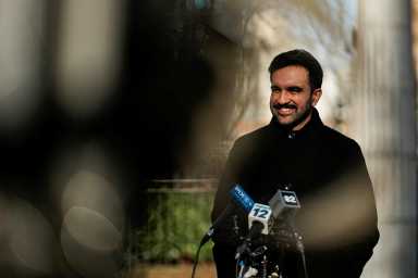 Mayor Zohran Mamdani smiling in front of camera