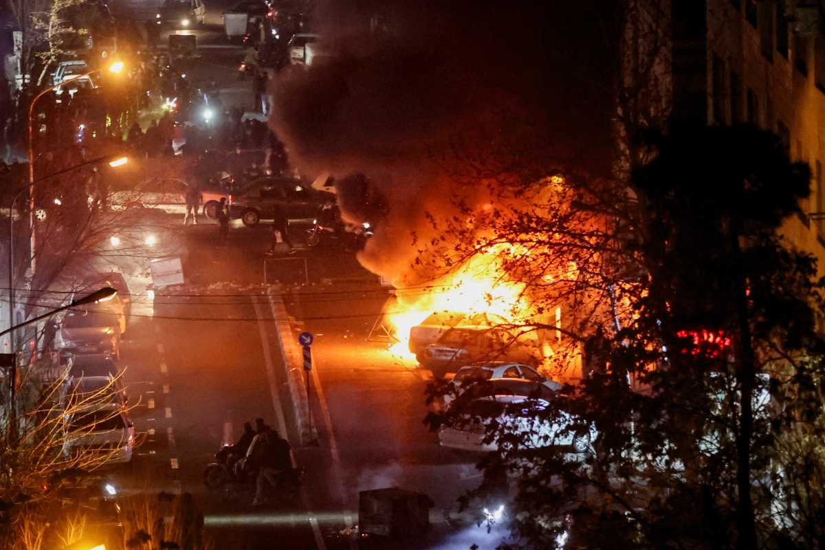 a fire in the street during protests in Iran