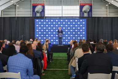 John Harbaugh Giants intro presser Super Bowl trophies backdrop