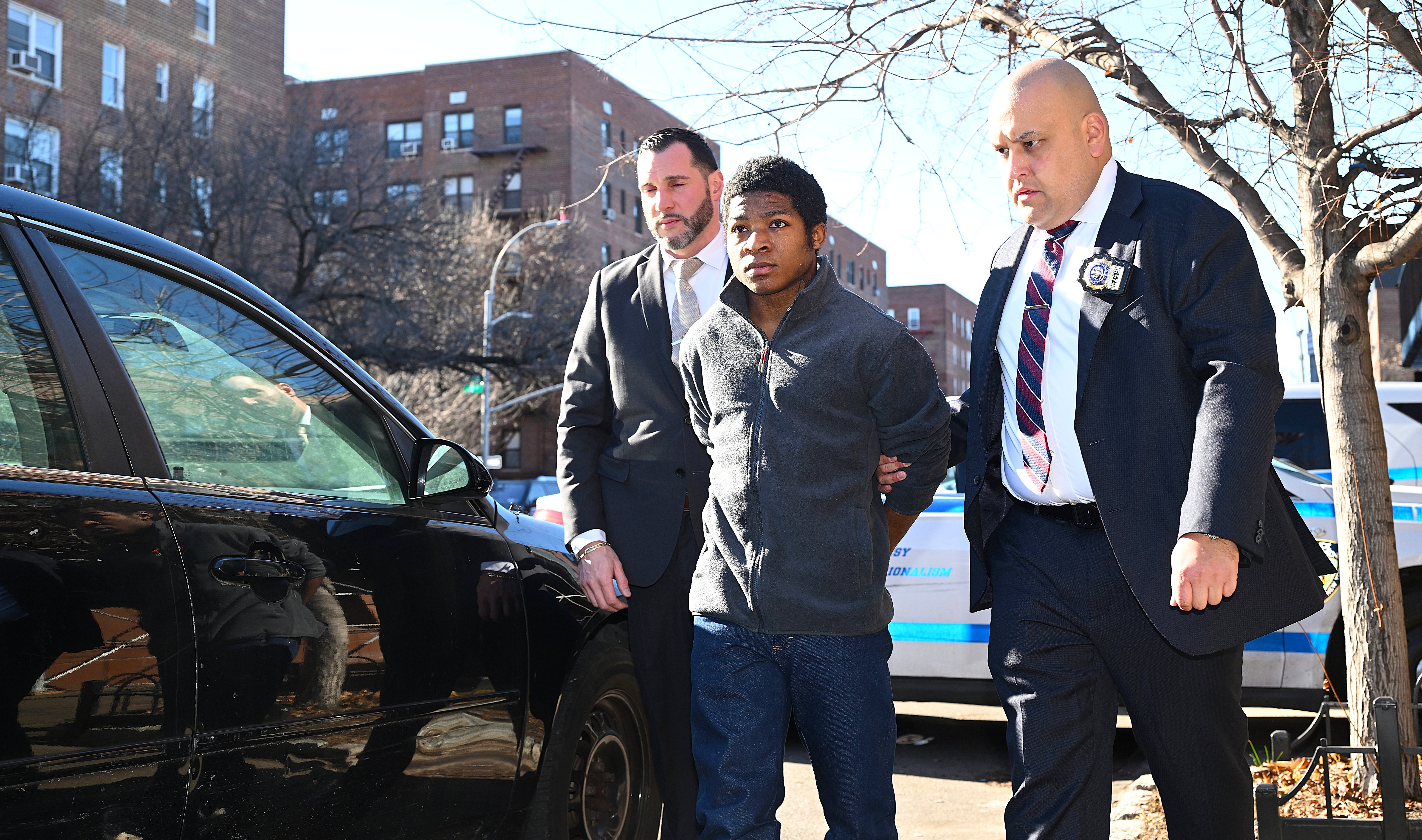 Suspect in Queens murder escorted into back of police car