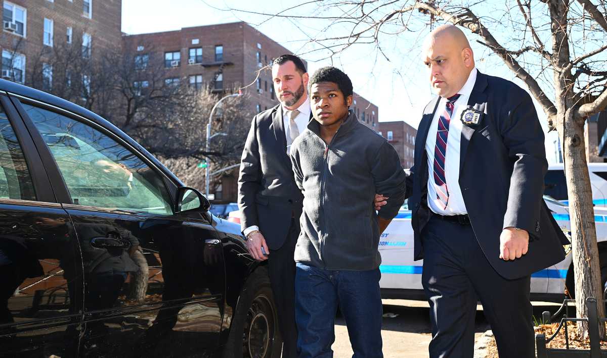 Suspect in Queens murder escorted into back of police car