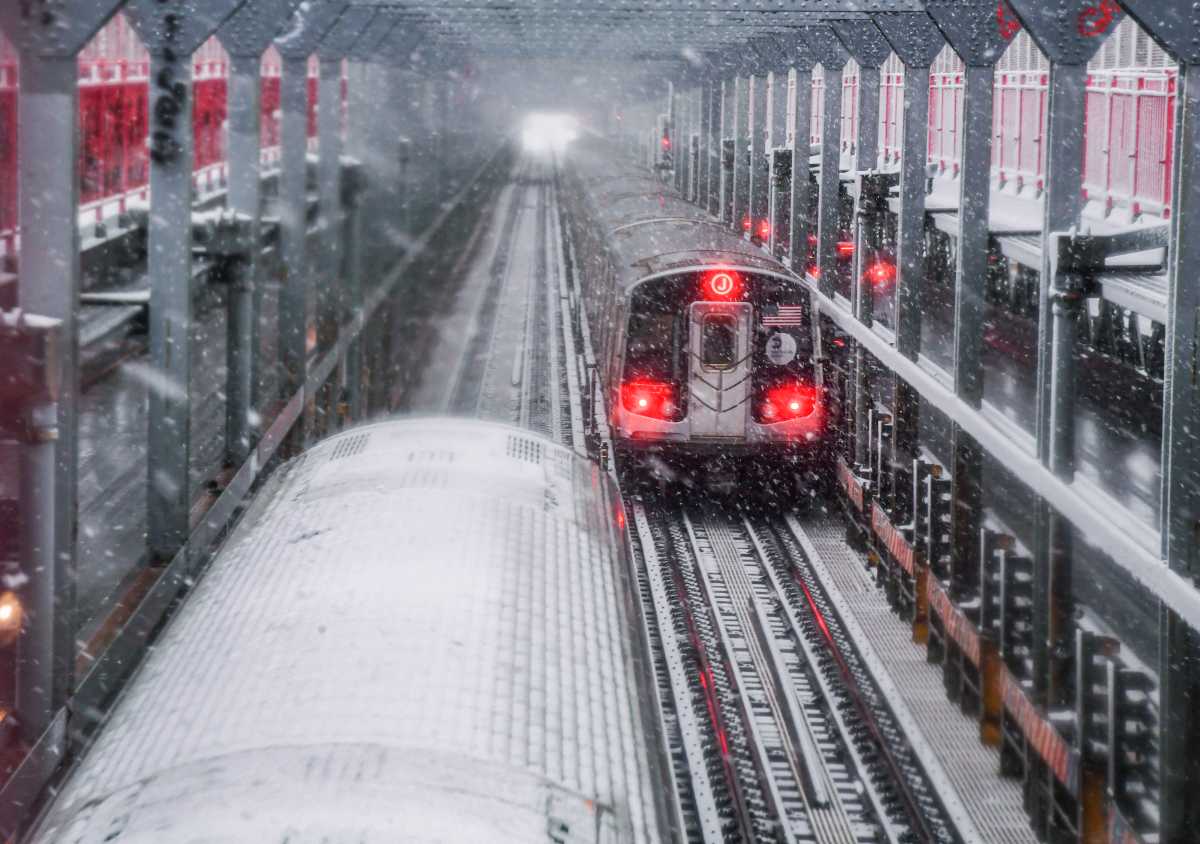 MTA subways traveling through a winter storm