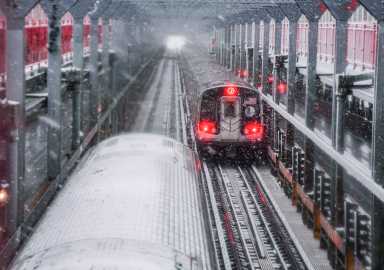 MTA subways traveling through a winter storm