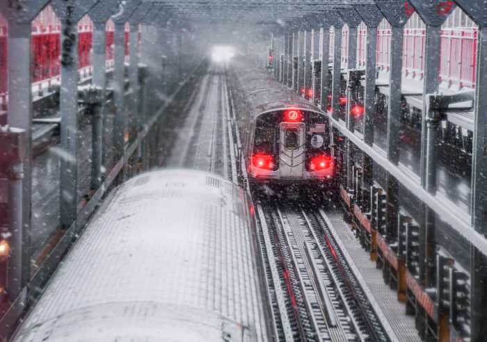 MTA subways traveling through a winter storm