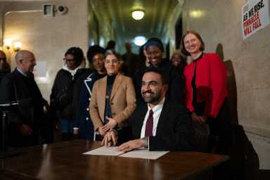 Mayor Zohran Mamdani pictured signing three of his first five executive orders aimed at tackling the city’s housing crisis during a press conference at an apartment building in Brooklyn