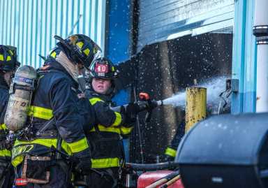 firefighters in brooklyn fight a four-alarm fire at a warehouse