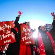 NURSES STRIKE: Talks between union and hospitals resumed Thursday amid ongoing walkout 6 people wearing red clothes and holding red signs during the nurses strike in NYC