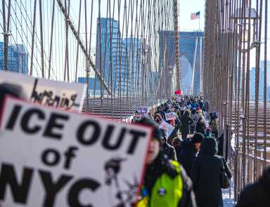 People marching on MLK Day across the Brooklyn Bridge against ICE
