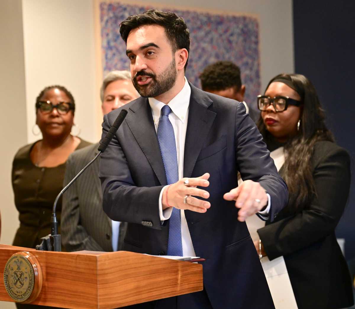 Mayor Mamdani speaking at podium and gesturing with his hands