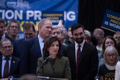 Gov. Kathy Hochul (centrer) with Mayor Zohran Mamdani (right) and MTA Chair and CEO Janno Lieber (left) at a press conferencing celebrating the one-year anniversary of congestion pricing. Monday, Jan. 5, 2026.