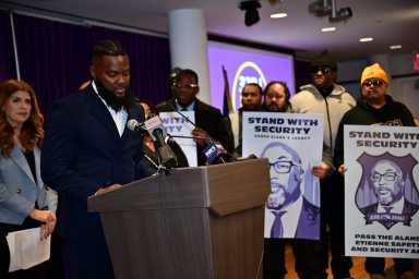 Rally attendee speaks on bill to improve wages for security guards