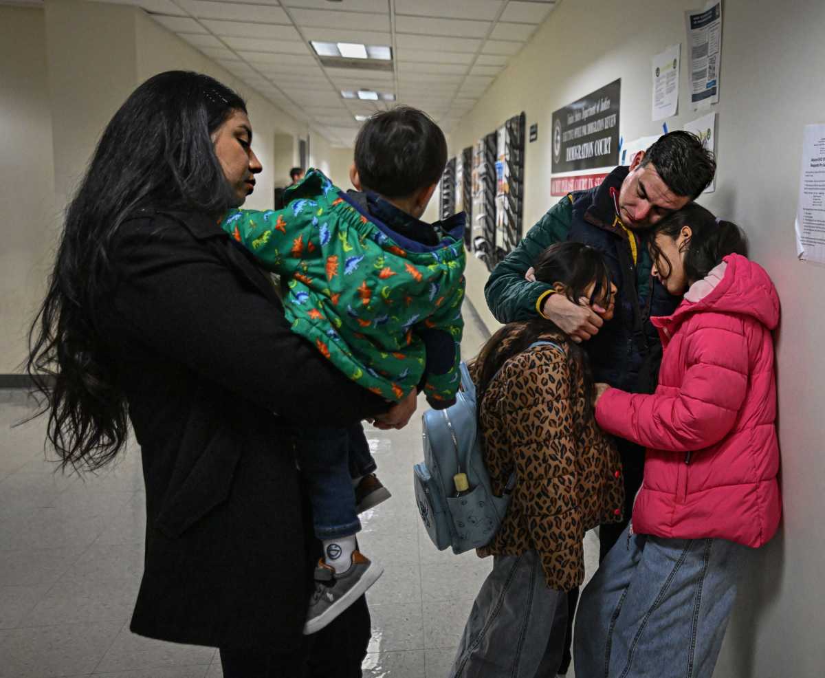 family clutching at Federal Plaza immigration court room awaiting ICE hearing