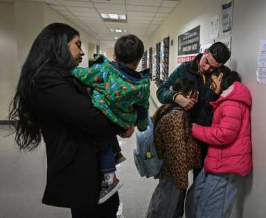 family clutching at Federal Plaza immigration court room awaiting ICE hearing