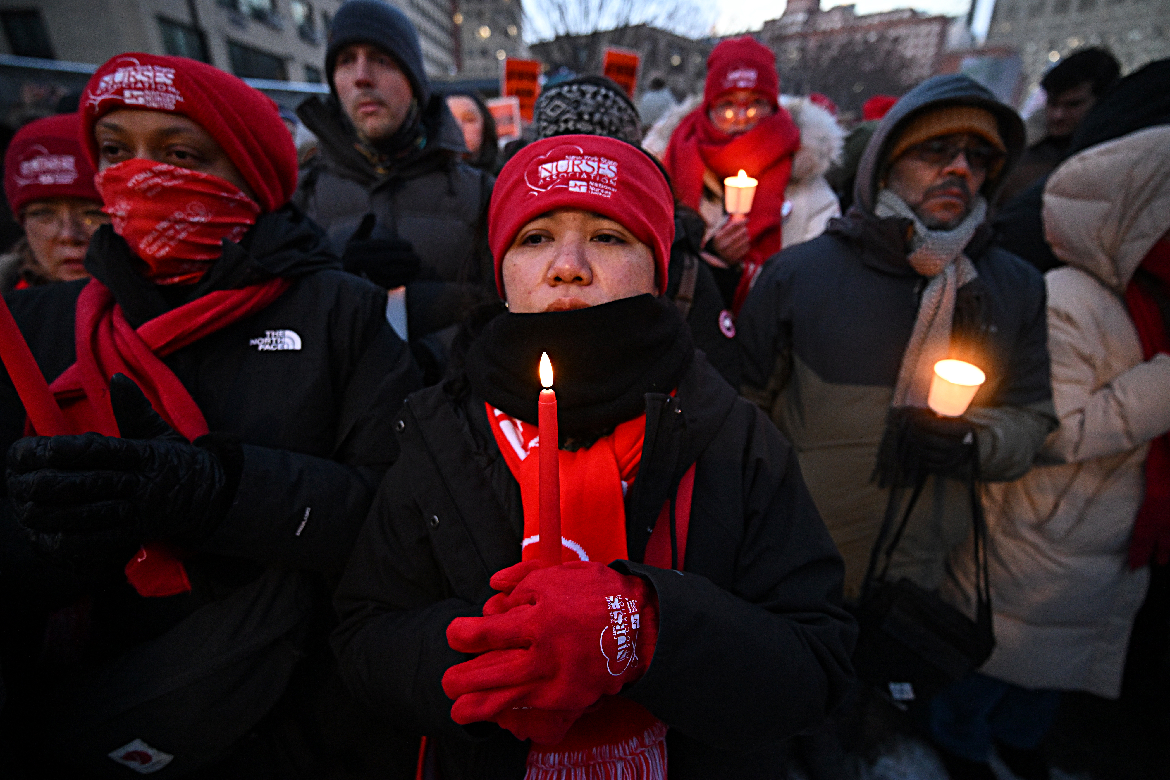 Nurses hold candles for Alex Pretti at vigil