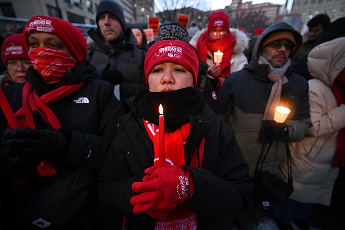 Nurses hold candles for Alex Pretti at vigil