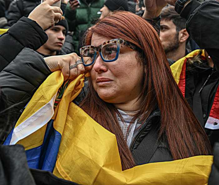 Venezuelan woman with flag weeps at Nicolas Maduro arraignment