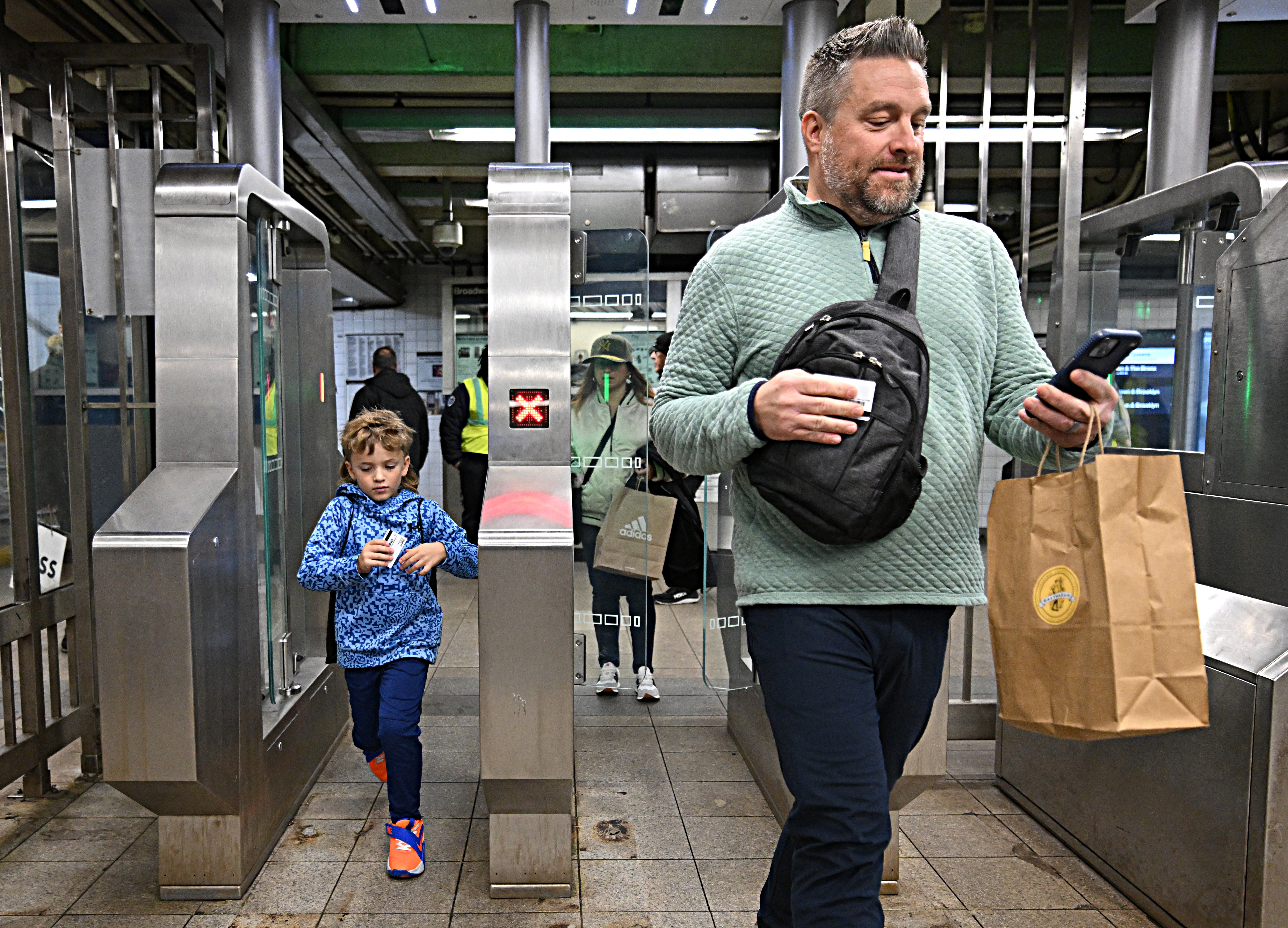People walking through new fare gates designed to stop fare evasion