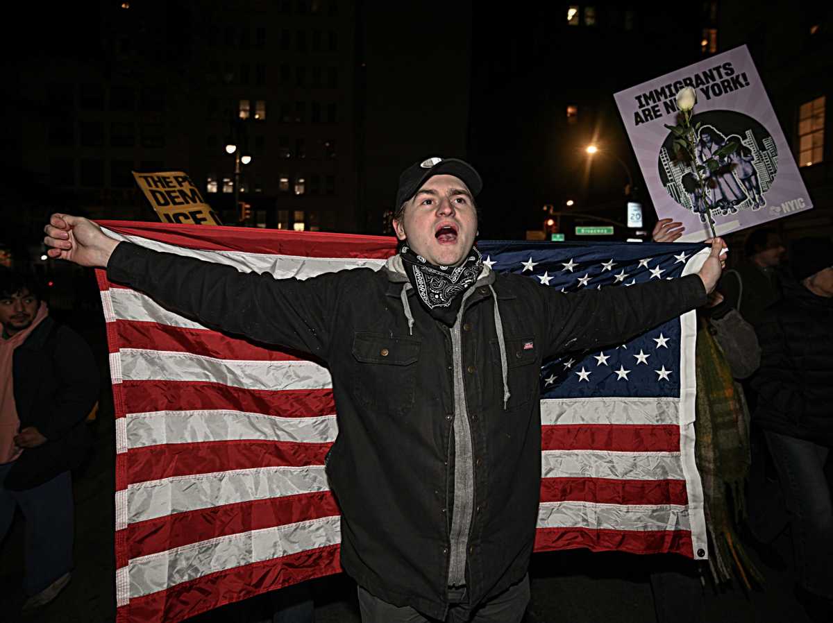 Man with American flag protesting in Foley Square after ICE shooting in Minneapolis