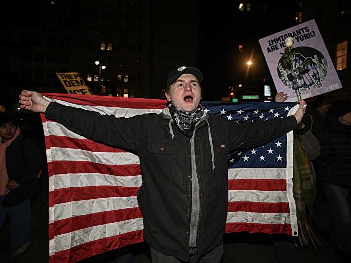 Man with American flag protesting in Foley Square after ICE shooting in Minneapolis