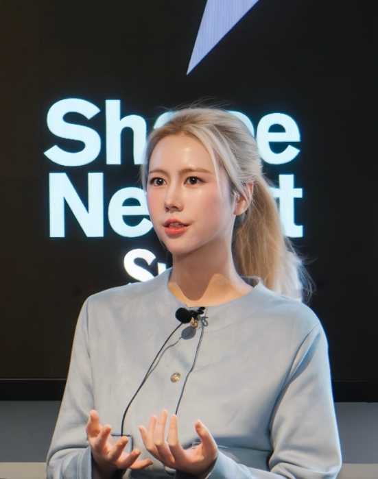 Cherriana Wang, who is living the American dream, standing in front of a microphone