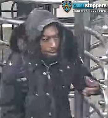 man in a subway station wearing black jacket