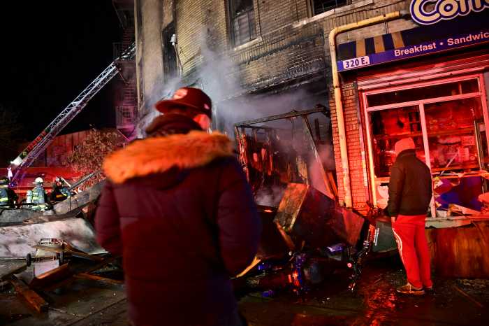 People looking at the effects of a devastating fire.