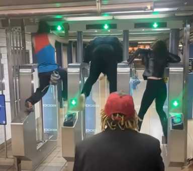 People hopping over modern turnstiles in "Fare Evasion Olympics" at Manhattan station