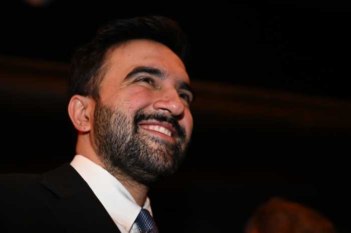 man smiling while wearing a suit