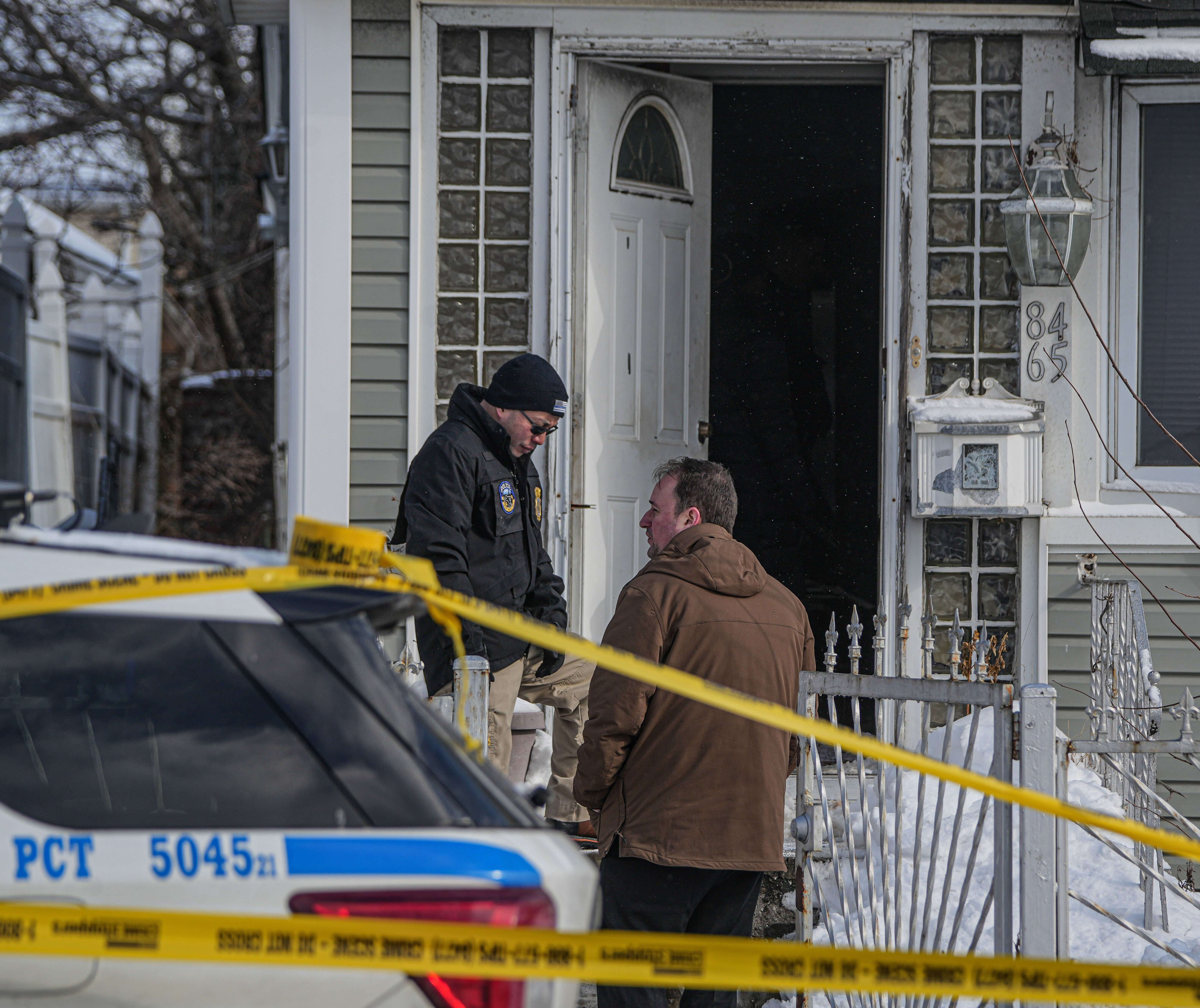 detectives at front door of Queens home after police-involved shooting