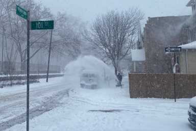 Man using snowblower during winter storm in NYC