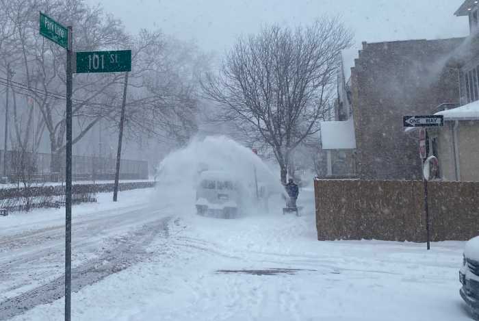Man using snowblower during winter storm in NYC