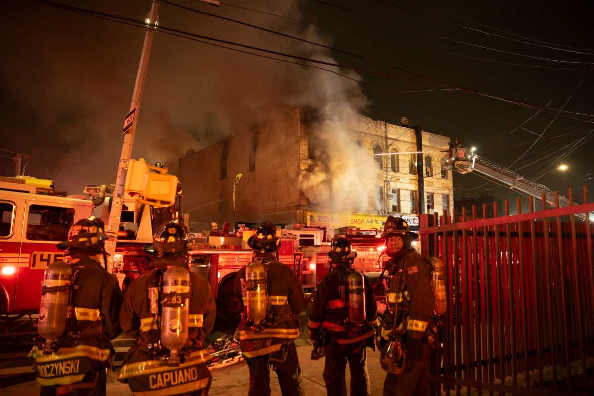 Queens three-alarm fire at tire shop and apartment building injures two firefighters  amNewYork