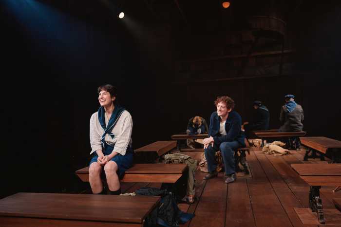 REVIEW | ‘Marcel on the Train’ finds the bravery behind the beret 3 actors perform on a stage with a dark background