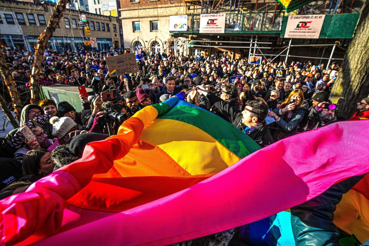 The Pride flag makes its way through the crowd.