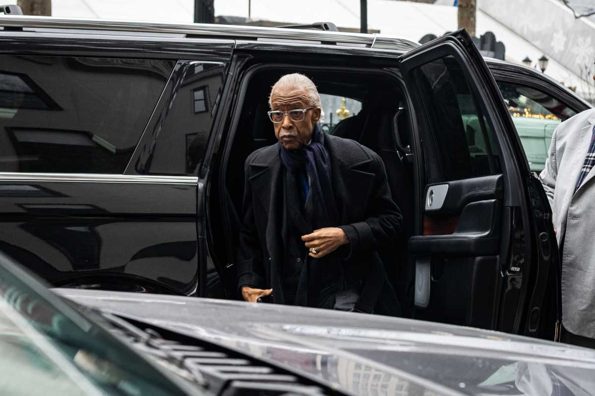 Reverend Al Sharpton exits car to speak about late Jesse Jackson