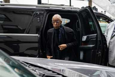Reverend Al Sharpton exits car to speak about late Jesse Jackson