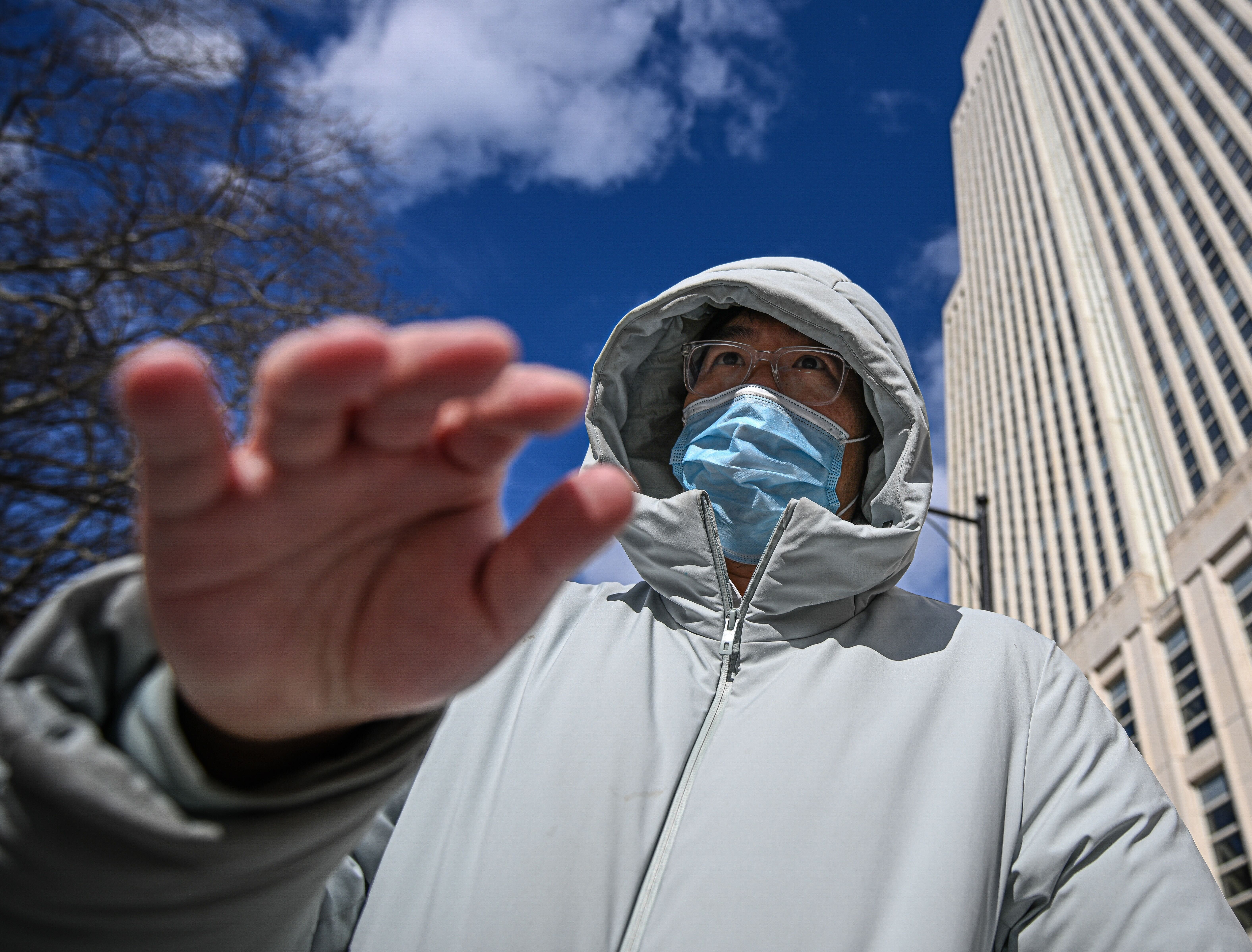 Queens assistant principal waves hand at camera after arrest for allegedly pimping porn performer