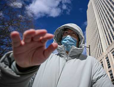 Queens assistant principal waves hand at camera after arrest for allegedly pimping porn performer
