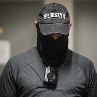 Cameras and covered faces: some ICE agents begin using body cams in 26 Federal Plaza 5 person wearing a hat and mask