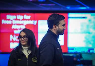 two people standing in front of a screen